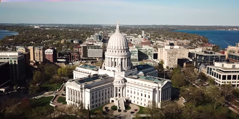 overhead shot of Wisconsin's capitol building with city and lakes in background